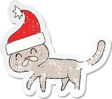 retro distressed sticker of a cartoon cat wearing christmas hat vector