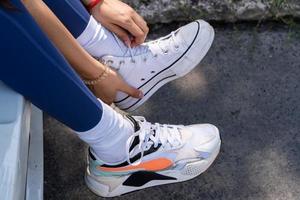 young woman wears running shoes for exercise, photo