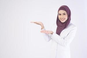 Beautiful muslim business woman wearing white suit with hijab in studio photo