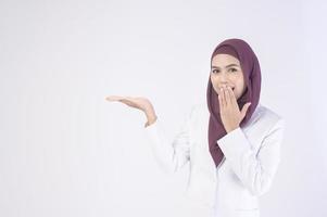 Beautiful muslim business woman wearing white suit with hijab in studio photo