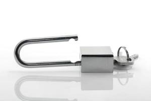 Metallic padlock with  keys on white background photo