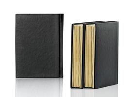 Closed black book is laying on white background photo