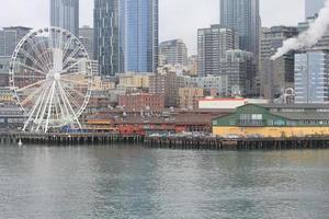 seattles , USA - March, 10 2022  Tall buildings, steam fumes, the seattles in the city The Seattle Great Wheal ferry terminal area. photo