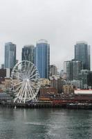 seattles , USA - March, 10 2022  Tall buildings, steam fumes, the seattles in the city The Seattle Great Wheal ferry terminal area. photo