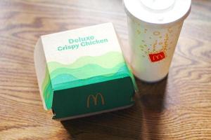 Washington  America June 17 2022  McDonald's deluxe Crispy Chicken Burger Box made from recycled paper with a glass of Pepsi. photo