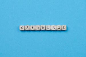 the German word Gasumlage means gas levy on blue background photo