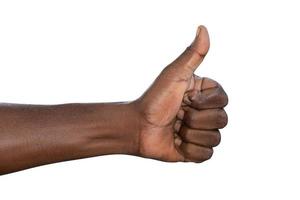 Closeup of male hand showing thumbs up sign against white background photo