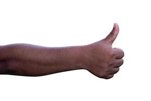 Closeup of male hand showing thumbs up sign against photo