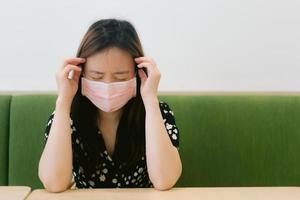 Asian office worker Wearing Protective Mask. Feeling sick and tired. photo