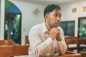 Christian faith towards God concept, Asian man christians worship and pray in church. photo