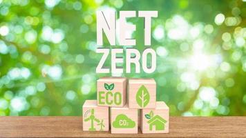The eco icon on wood cube for net zero concept 3d rendering photo