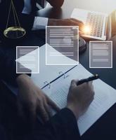 Justice and law concept.Male judge in a courtroom with the gavel, working with, computer and docking keyboard, eyeglasses, on table in morning light photo