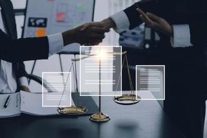 Justice and law concept.Male judge in a courtroom with the gavel, working with, computer and docking keyboard, eyeglasses, on table in morning light photo