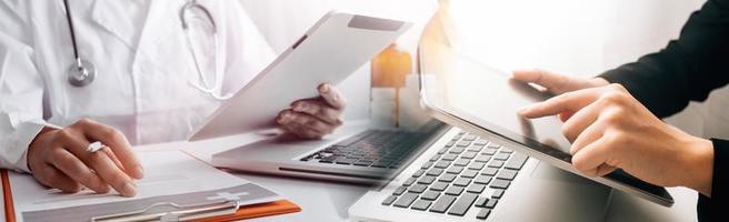 Medicine doctor and stethoscope touching icon medical network connection with modern interface on digital tablet in hospital background. Medical technology network concept photo