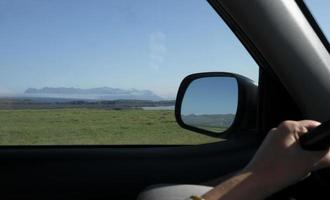 Road trip through Iceland with the landscape seen through the window and the mirror photo