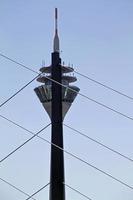 Rheinturm in Dusseldorf half hidden behind a bridge photo