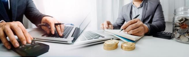 Business accounting concept, Business man using calculator with computer laptop, budget and loan paper in office. photo