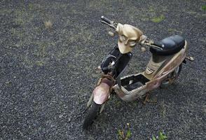 Abandoned moped with a golden mask photo