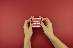 a woman decorating the present for Christmas holidays photo