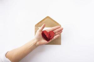 A brown envelope with red hearts in it for Valentines Day photo