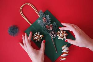 A woman decorating presents and gifts for Christmas holidays photo