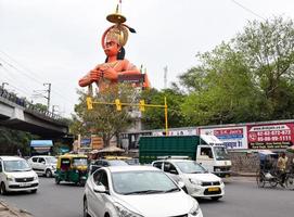 New Delhi, India - June 21, 2022 - Big statue of Lord Hanuman near the delhi metro bridge situated near Karol Bagh, Delhi, India, Lord Hanuman statue touching sky photo