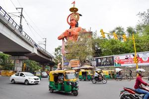 New Delhi, India - June 21, 2022 - Big statue of Lord Hanuman near the delhi metro bridge situated near Karol Bagh, Delhi, India, Lord Hanuman statue touching sky photo