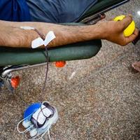 Blood donor at Blood donation camp held with a bouncy ball holding in hand at Balaji Temple, Vivek Vihar, Delhi, India, Image for World blood donor day on June 14 every year, Blood Donation Camp photo