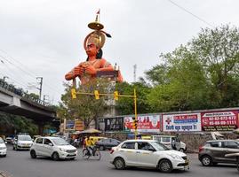 New Delhi, India - June 21, 2022 - Big statue of Lord Hanuman near the delhi metro bridge situated near Karol Bagh, Delhi, India, Lord Hanuman statue touching sky photo