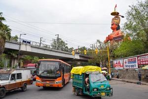 New Delhi, India - June 21, 2022 - Big statue of Lord Hanuman near the delhi metro bridge situated near Karol Bagh, Delhi, India, Lord Hanuman statue touching sky photo