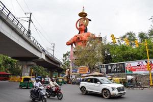 New Delhi, India - June 21, 2022 - Big statue of Lord Hanuman near the delhi metro bridge situated near Karol Bagh, Delhi, India, Lord Hanuman statue touching sky photo