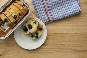 Blueberry Muffin Cake in Loaf Pan on wooden tabletop with napkin photo
