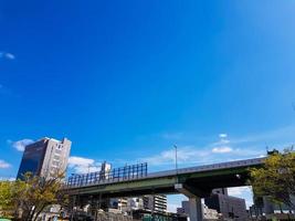 The side view of an overpass bridge in Osaka, shows a girder made of high tensile steel in green and gray. photo