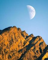 Moon transition across the sky with blue clear sky to cloud cover. Changing weather conditions watching moon photo