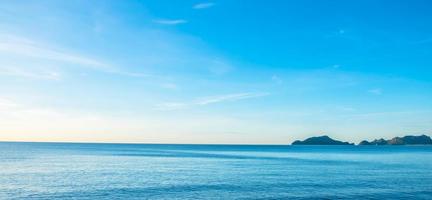 The view of the sea in the morning with the golden rays of the sun shining on the sea in summer photo