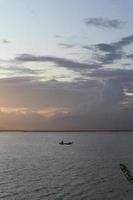 Fisherman Silhouette on His Boat photo