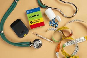 Fake medicine box with the name of the disease Coracao and a glucometer. photo