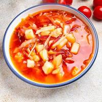 red vegetable soup borsch beetroot, cabbage, tomato, onion healthy meal food snack diet on the table copy space food background rustic top view keto or paleo diet veggie photo