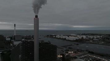 Aerial view of the Amager Bakke, Copenhill Waste-to-Energy Power Plant with green ski slopes with slides and kickers at sunset. Green eco energy plant. video