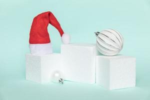 Simply minimal composition winter objects ornament and cube shapes geometric form podium isolated blue pastel background. Christmas New Year december time for celebration concept. Mockup, copy space photo