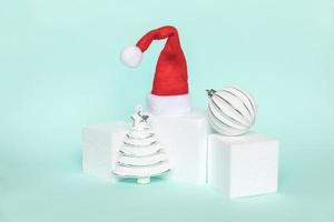Simply minimal composition winter objects ornament and cube shapes geometric form podium isolated blue pastel background. Christmas New Year december time for celebration concept. Mockup, copy space photo