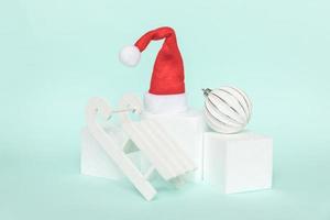 Simply minimal composition winter objects ornament and cube shapes geometric form podium isolated blue pastel background. Christmas New Year december time for celebration concept. Mockup, copy space photo