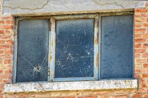 bullet holes on glass window photo