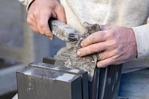 Old retired man hands working slate photo