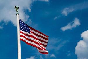 Giant Usa American flag stars and stripes on sky background photo