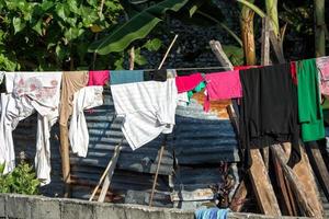 dress driying outside poor hovel, shanty, shack photo