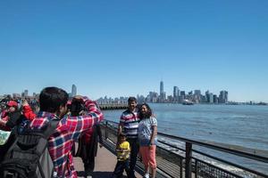 NEW YORK, USA - APRIL 22, 2017 - statue of liberty tourist selfie with smartphone photo