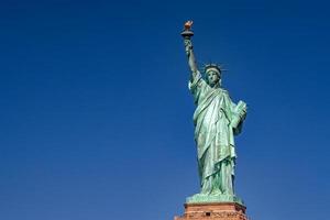 Statue of liberty in New York on blue sky photo