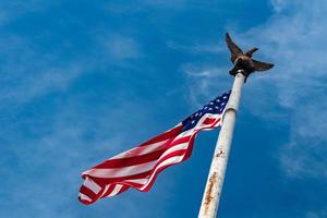 Giant Usa American flag stars and stripes on sky background photo