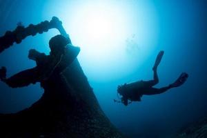 Ship Wreck propeller underwater with scuba diver silhouette photo